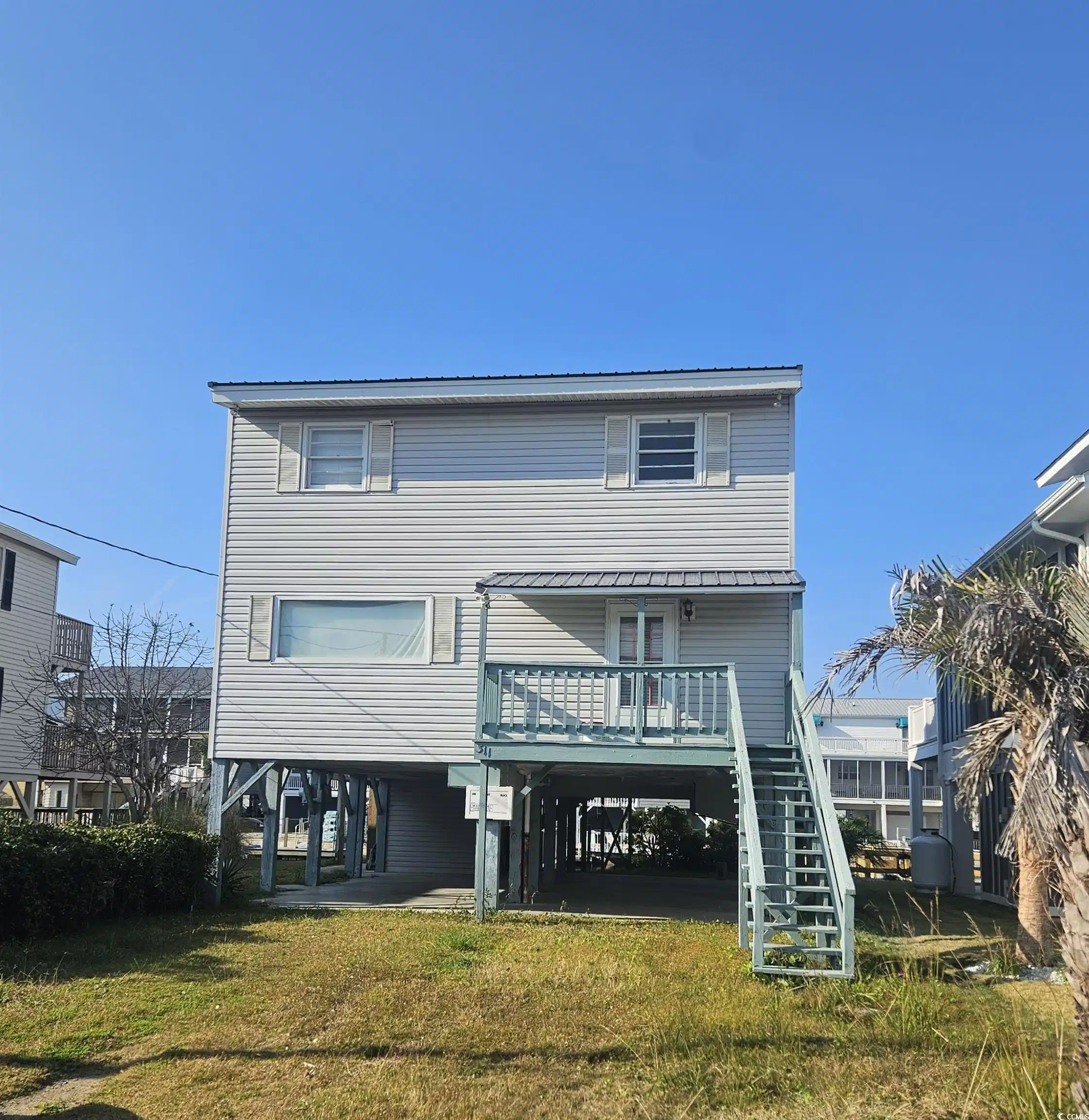 Image 1: Rear view of house featuring a carport, stairway, Image 1: Rear view of house featuring a carport, stairway,