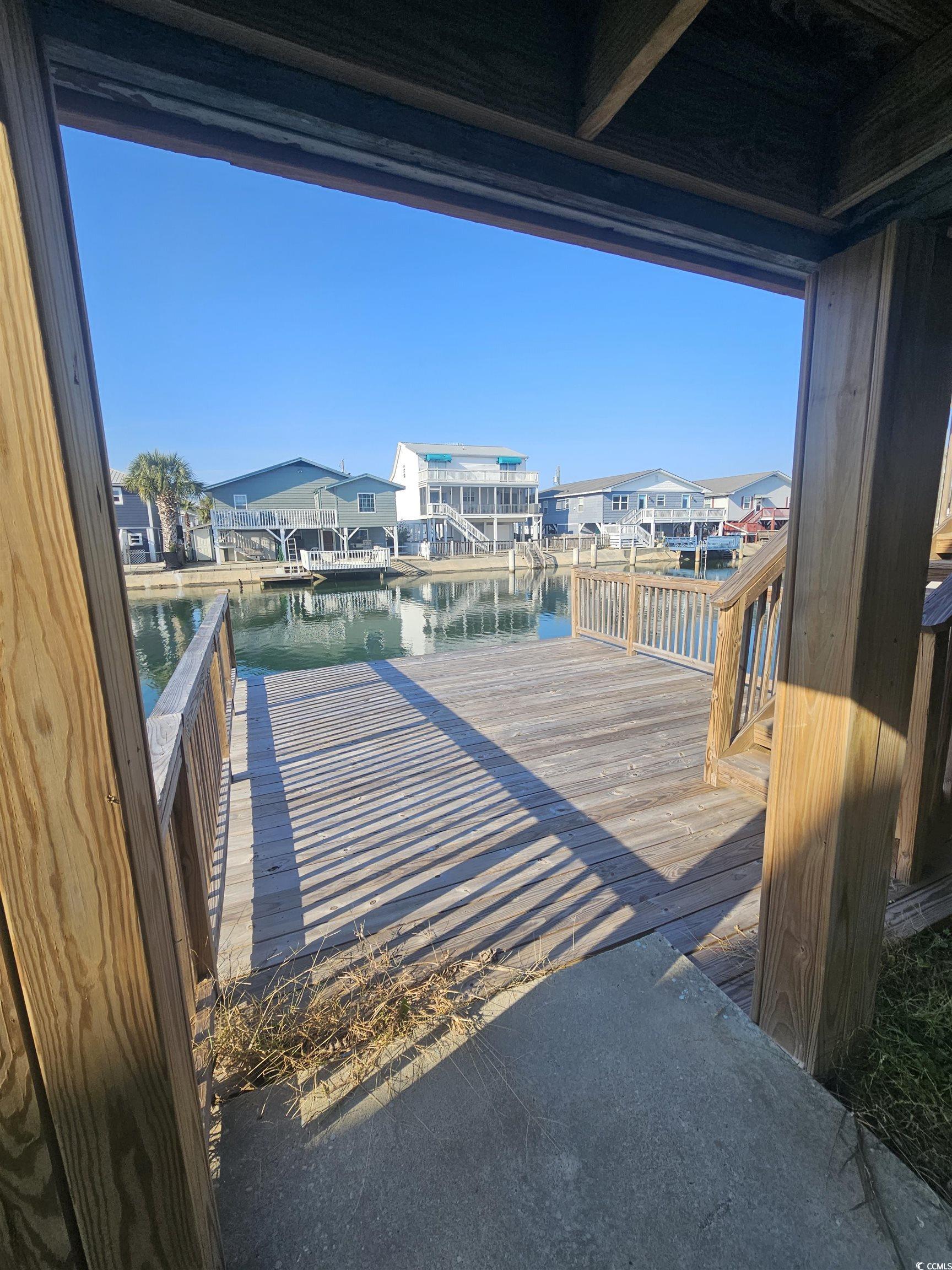 Image 2: Dock featuring a water view and a residential view Image 2: Dock featuring a water view and a residential view