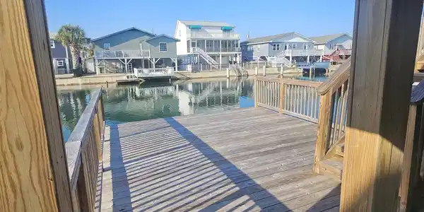 Image 2: Dock featuring a water view and a residential view Image 2: Dock featuring a water view and a residential view