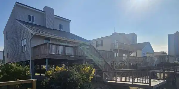 Image 3: Back of house featuring a deck with water view, a Image 3: Back of house featuring a deck with water view, a