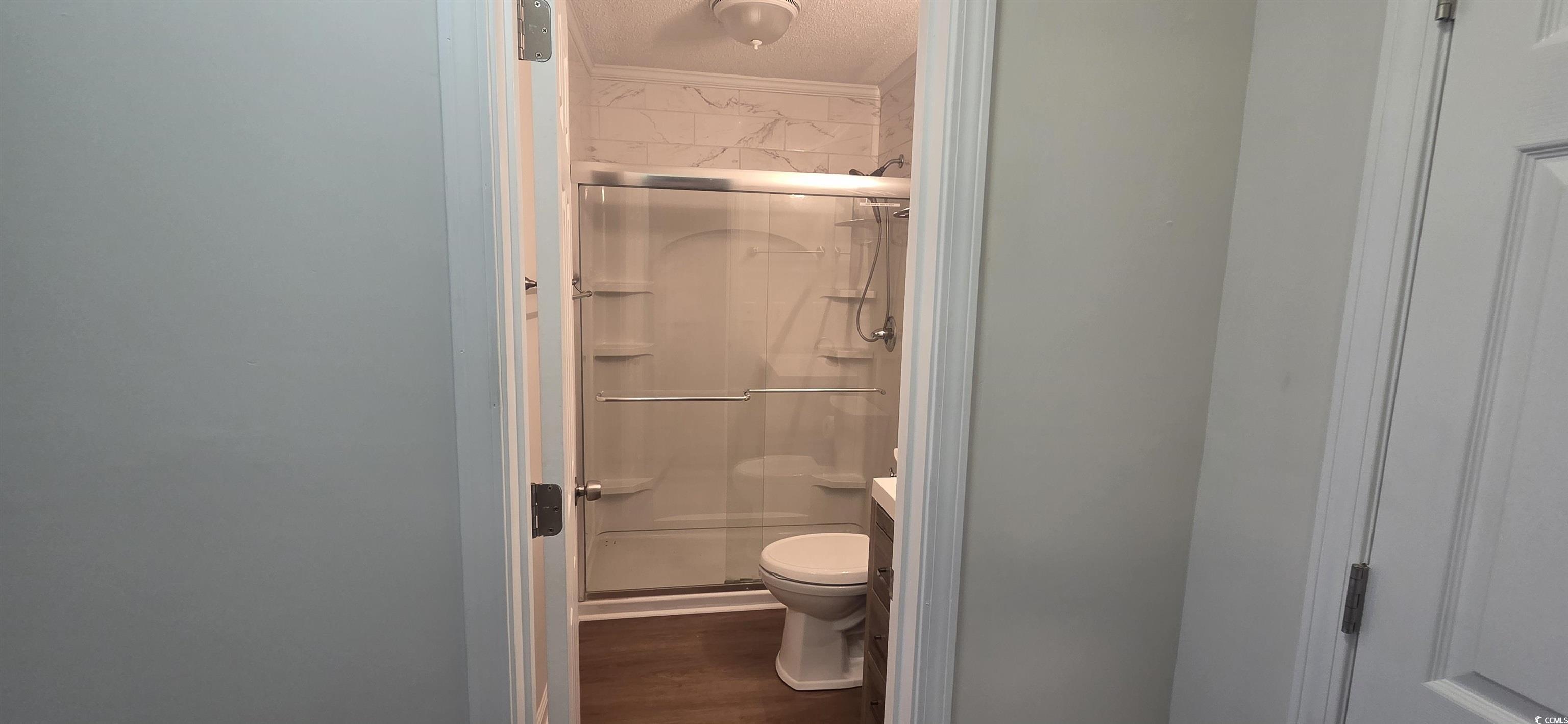 Image 3: Full bath featuring a stall shower, dark wood-styl Image 3: Full bath featuring a stall shower, dark wood-styl
