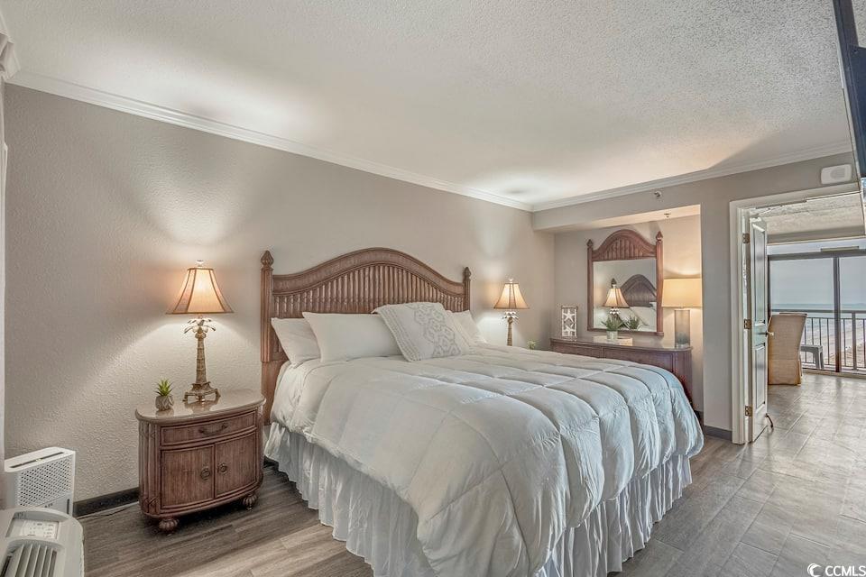 Image 2: Bedroom featuring ornamental molding, wood finishe Image 2: Bedroom featuring ornamental molding, wood finishe