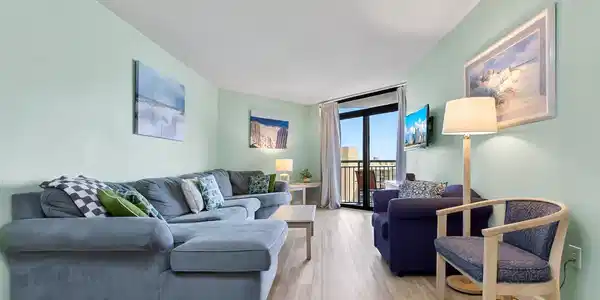 Image 2: Living area with a wall of windows and wood finish