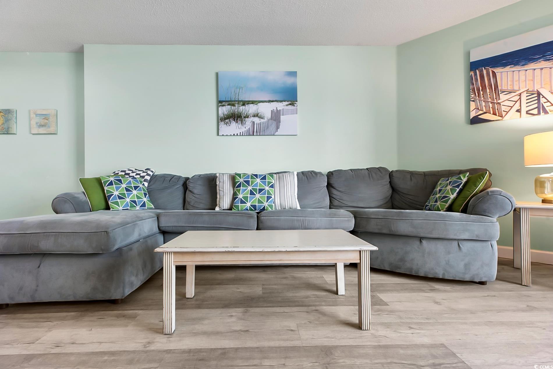 Image 4: Living area featuring wood finished floors