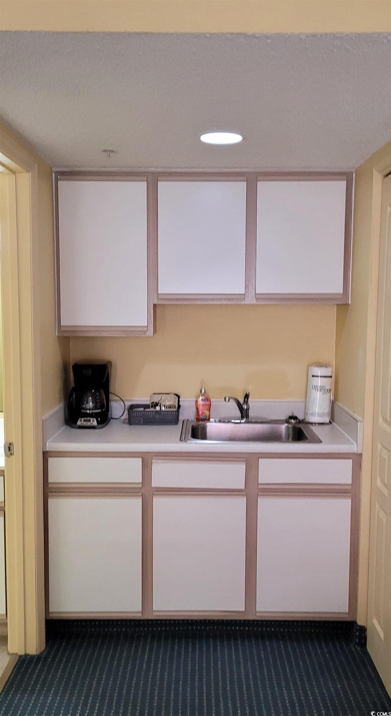 Image 3: Kitchen featuring sink, carpet floors, and white c