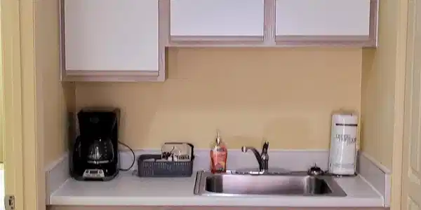 Image 3: Kitchen featuring sink, carpet floors, and white c