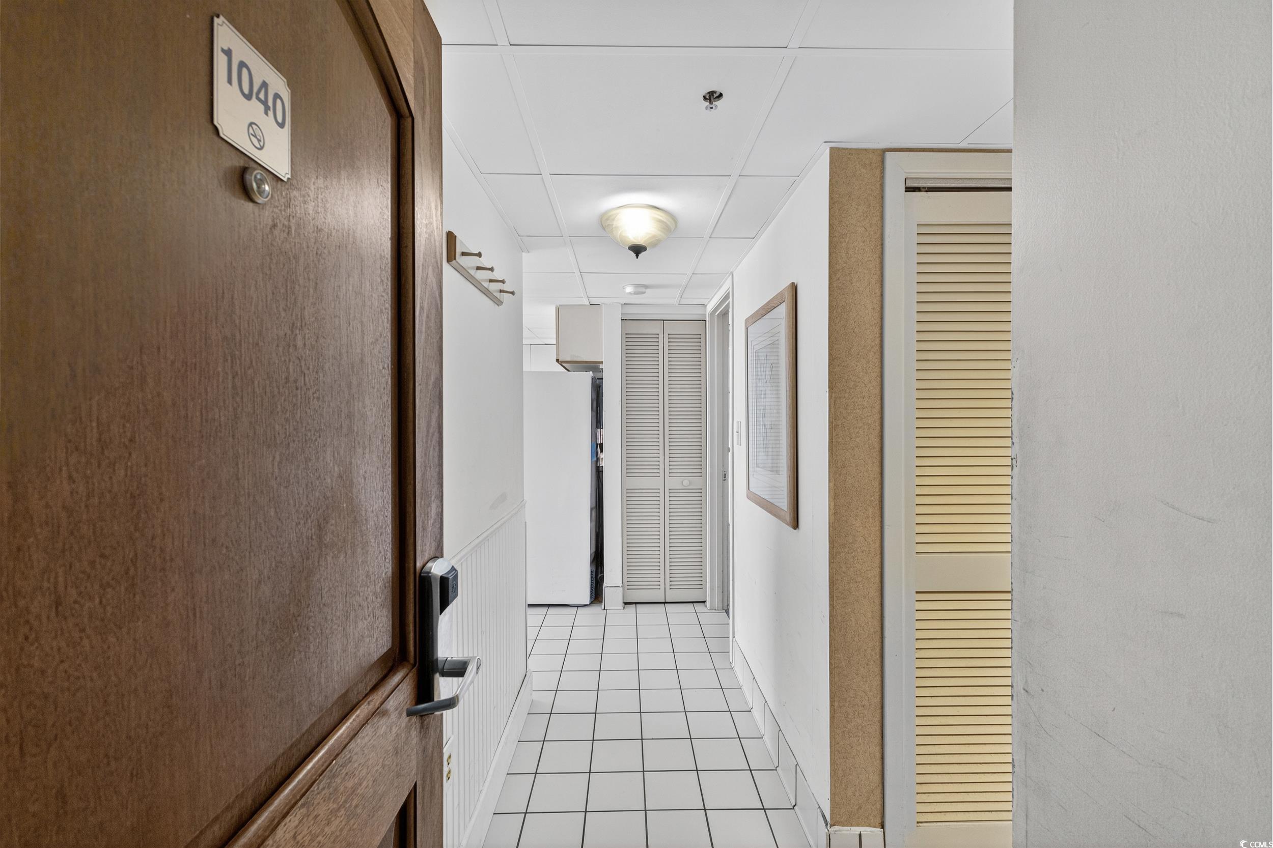 Image 3: Hallway with light tile patterned flooring and a p Image 3: Hallway with light tile patterned flooring and a p