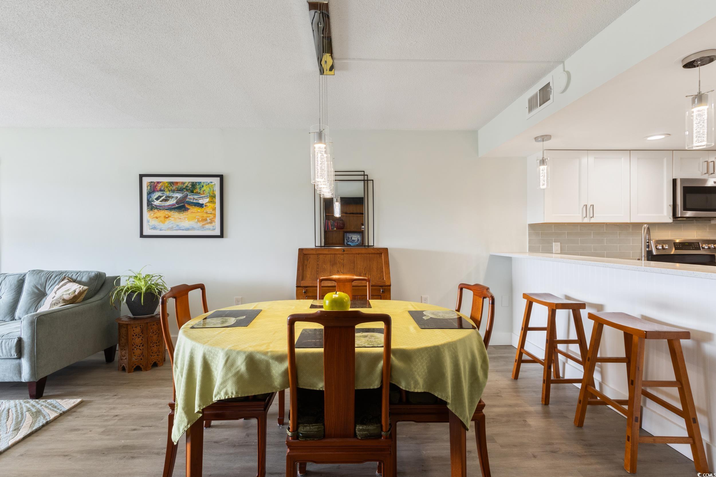Image 3: Dining area featuring light wood-type flooring