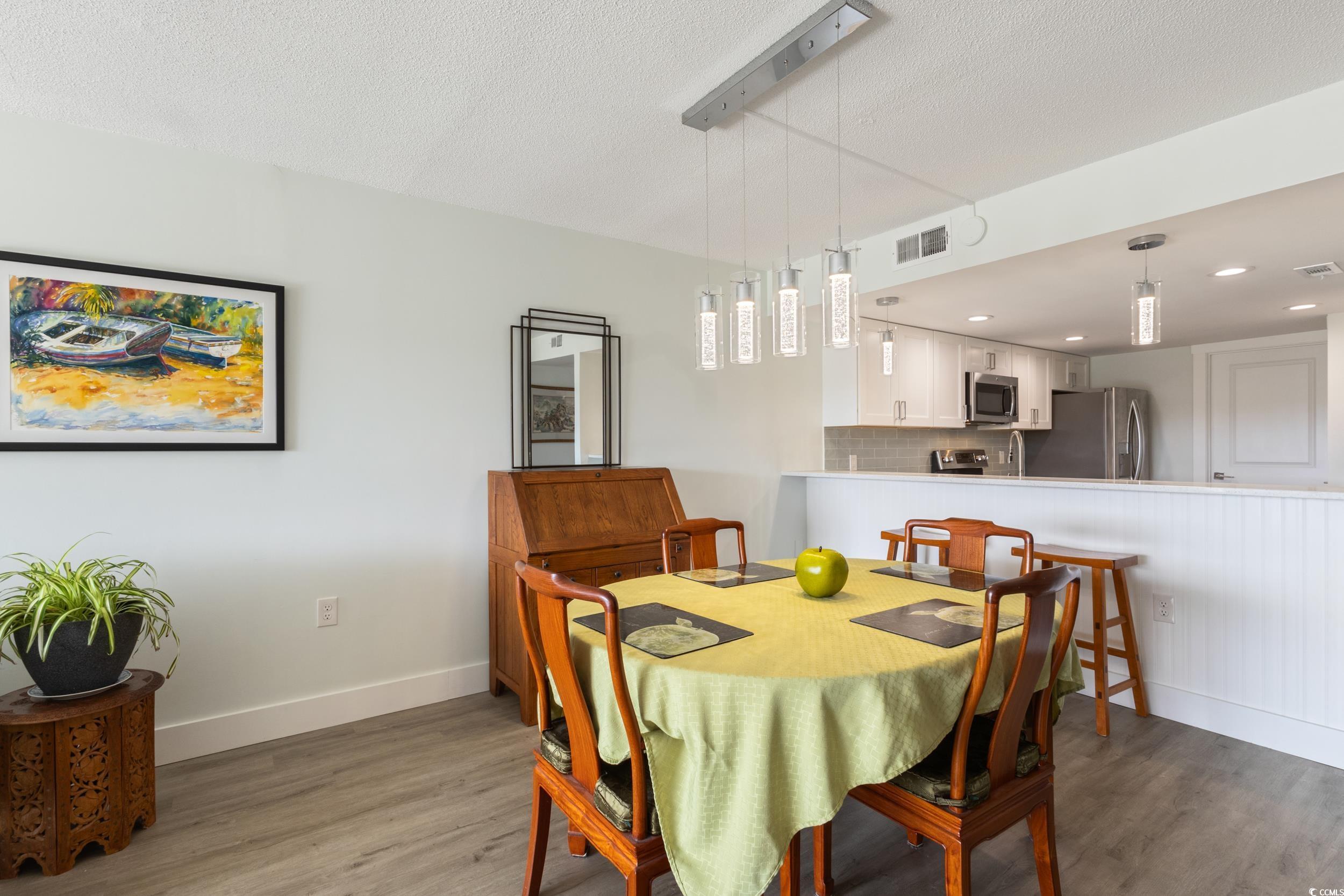 Image 4: Dining room featuring wood finished floors and a t