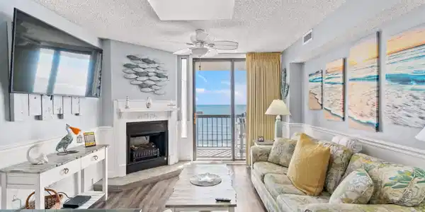 Image 2: Living room featuring a wall of windows, a firepla Image 2: Living room featuring a wall of windows, a firepla