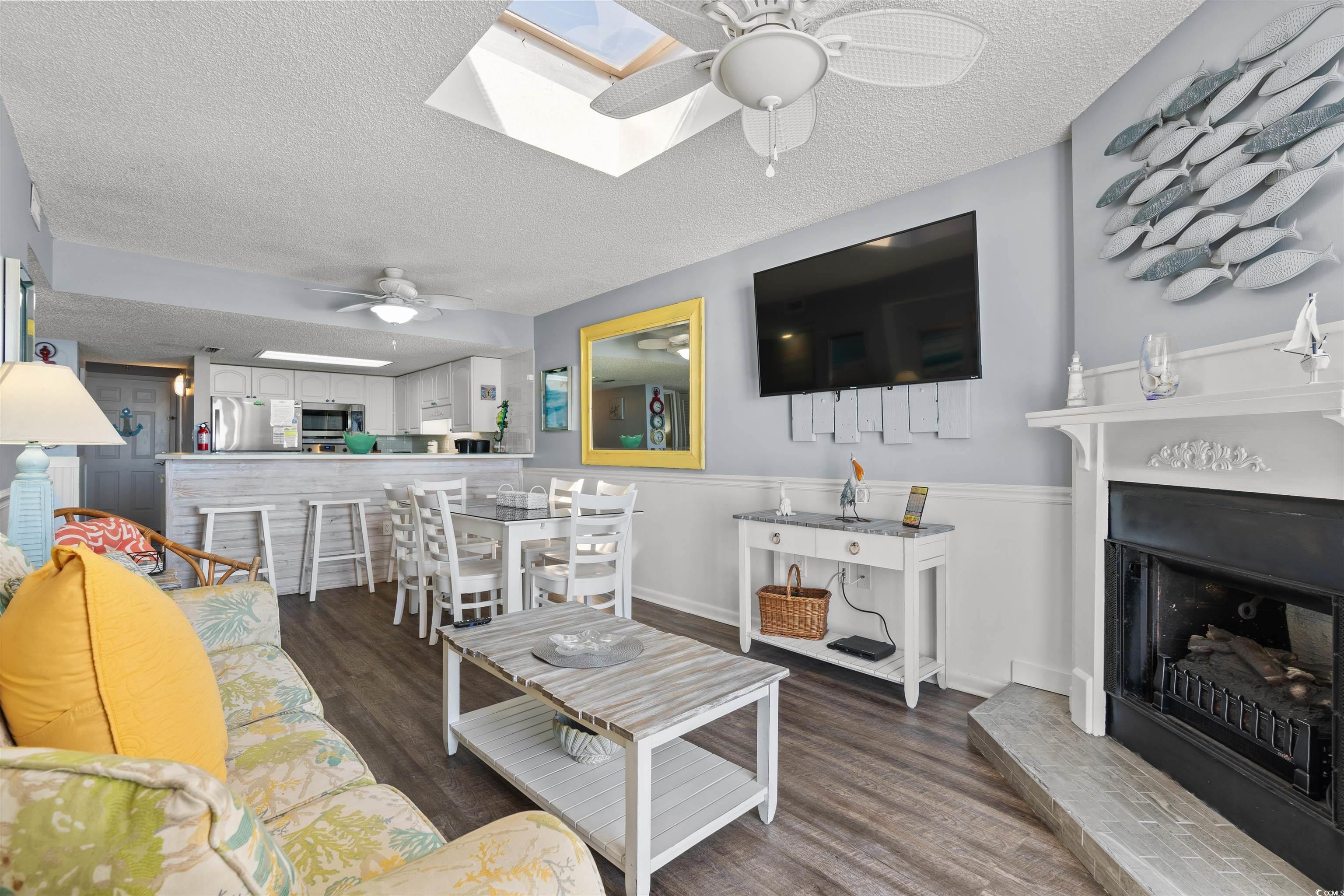 Image 3: Living area featuring ceiling fan, a textured ceil