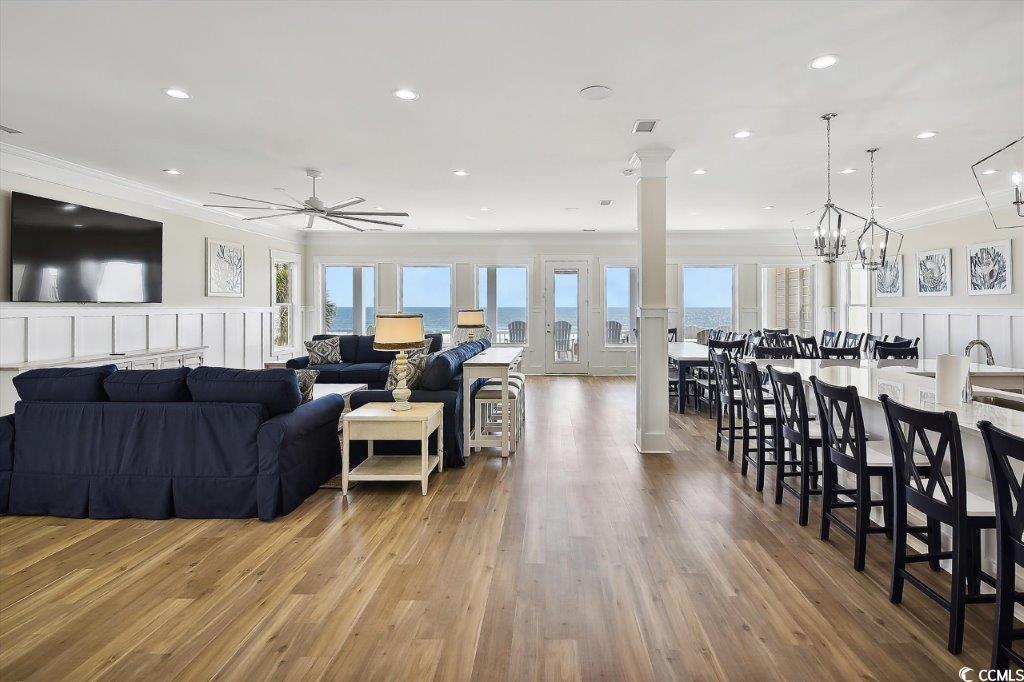 Image 2: Living room featuring a decorative wall, light woo Image 2: Living room featuring a decorative wall, light woo