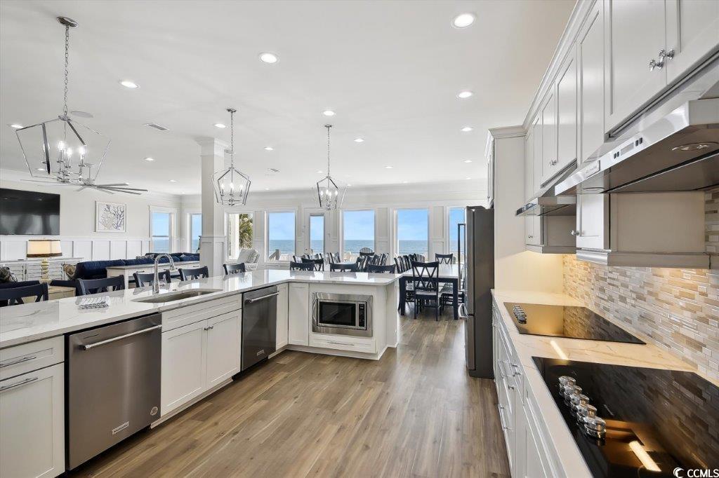 Image 4: Kitchen with white cabinets, open floor plan, stai Image 4: Kitchen with white cabinets, open floor plan, stai