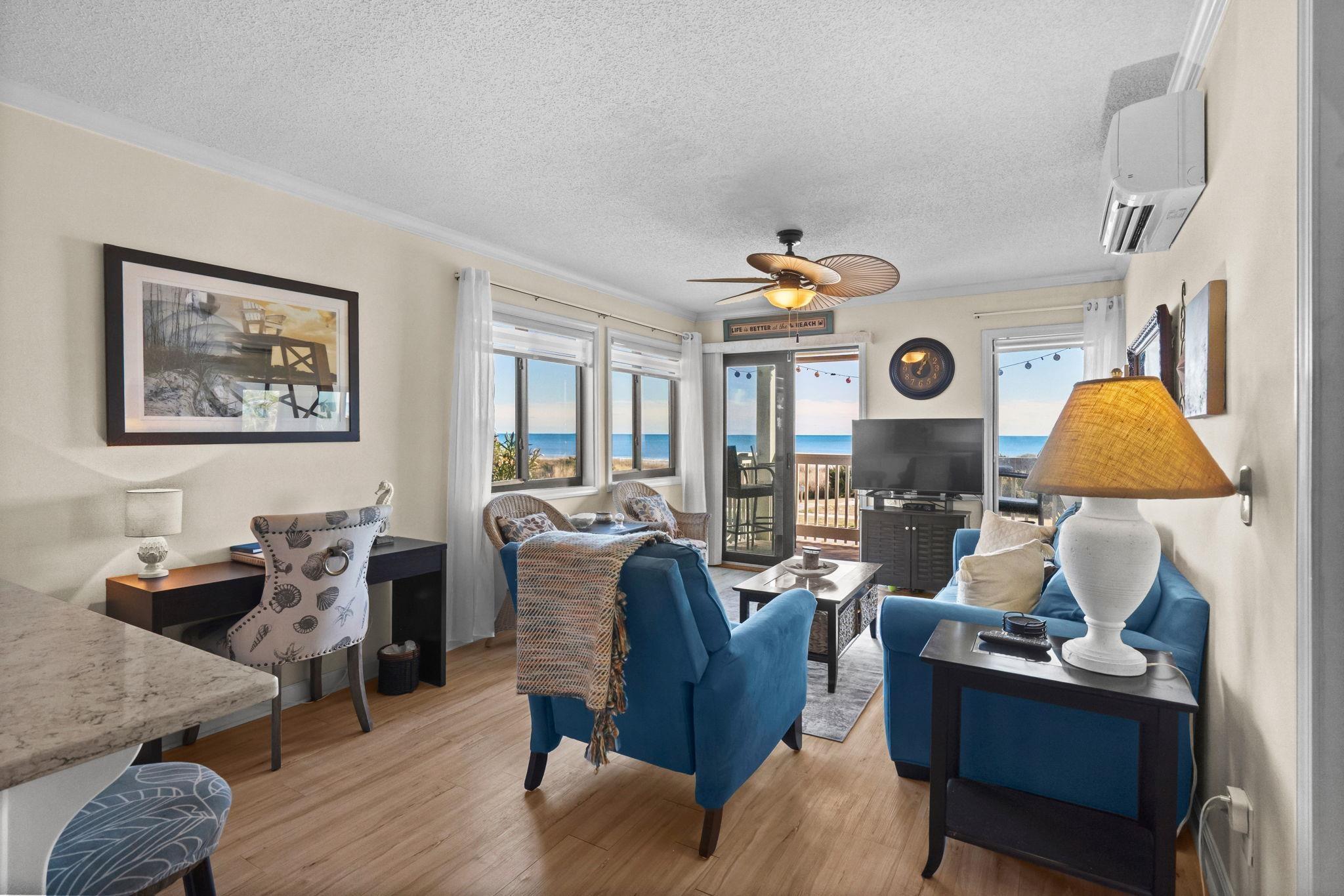 Image 2: Living area featuring a textured ceiling, light wo Image 2: Living area featuring a textured ceiling, light wo