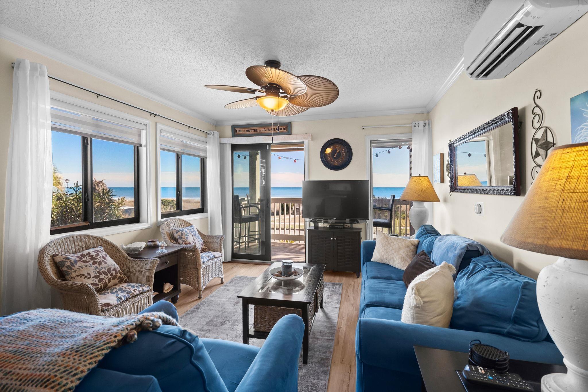 Image 3: Living area featuring a textured ceiling, a wall u Image 3: Living area featuring a textured ceiling, a wall u
