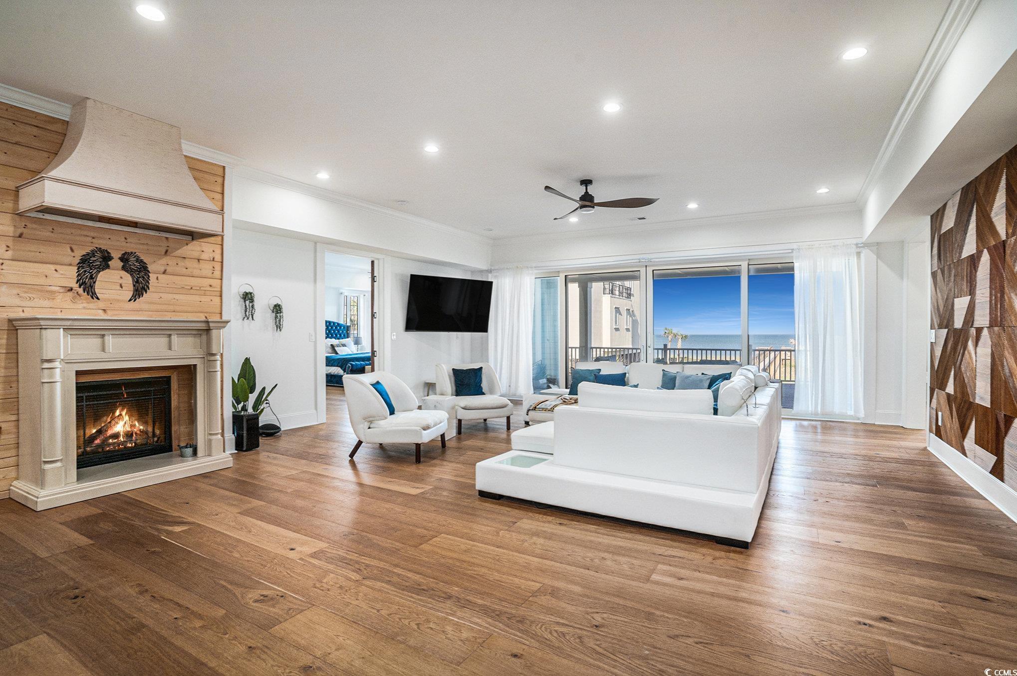 Image 3: Living area with crown molding, a ceiling fan, a l