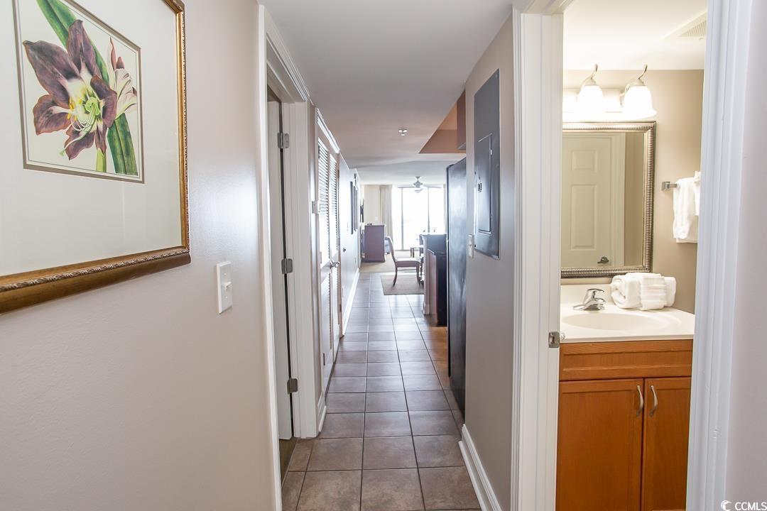 Image 4: Hallway with light tile patterned flooring and sin Image 4: Hallway with light tile patterned flooring and sin