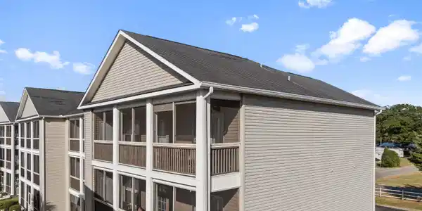 Image 2: View of the condos exterior screen porch from outs