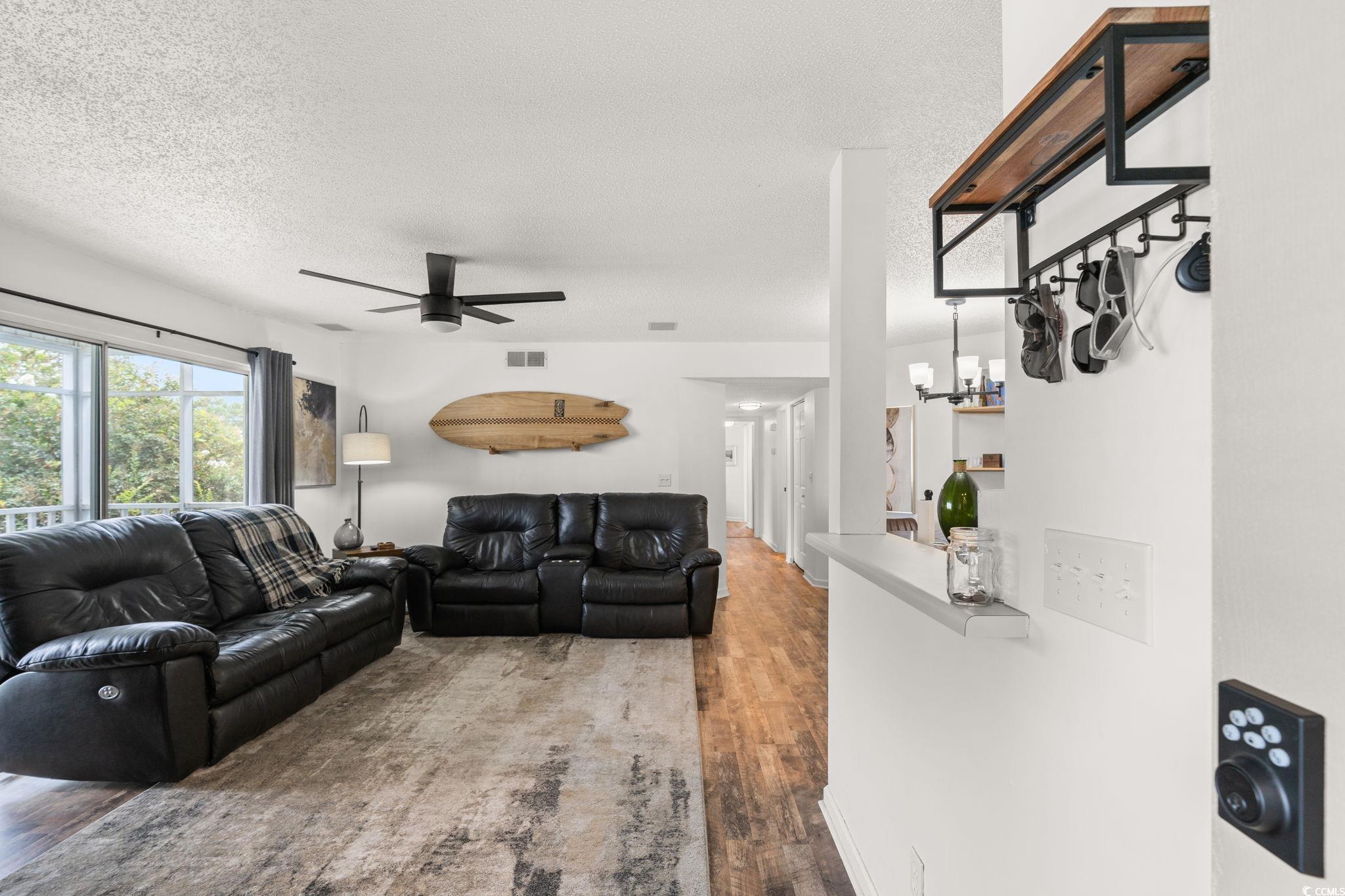 Image 2: Living area with a textured ceiling, wood finished Image 2: Living area with a textured ceiling, wood finished