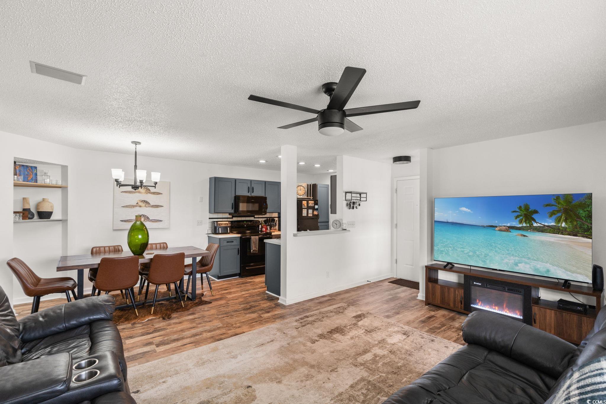 Image 4: Living room with wood finished floors, a chandelie Image 4: Living room with wood finished floors, a chandelie