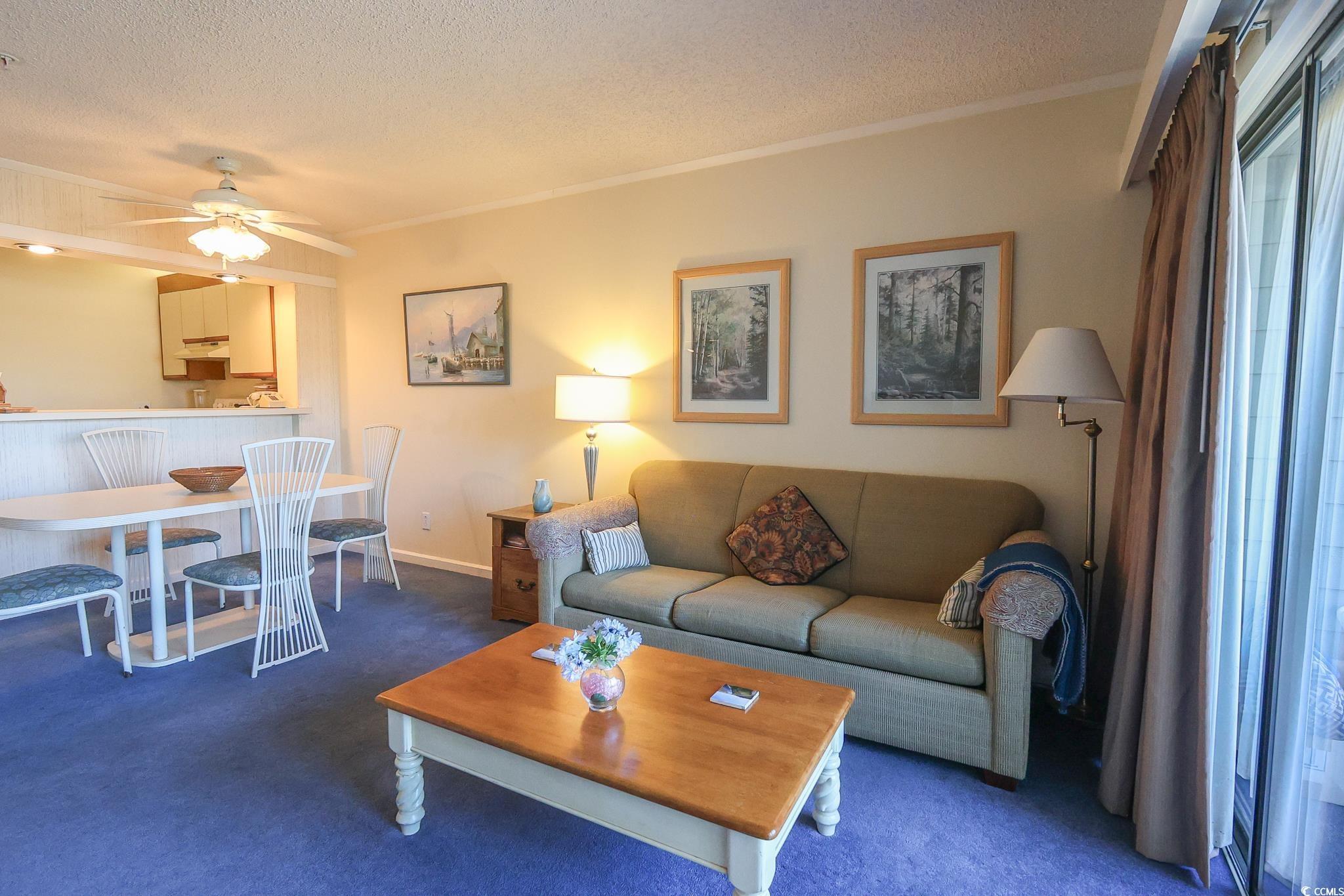 Image 4: Living room with a textured ceiling, carpet floori Image 4: Living room with a textured ceiling, carpet floori