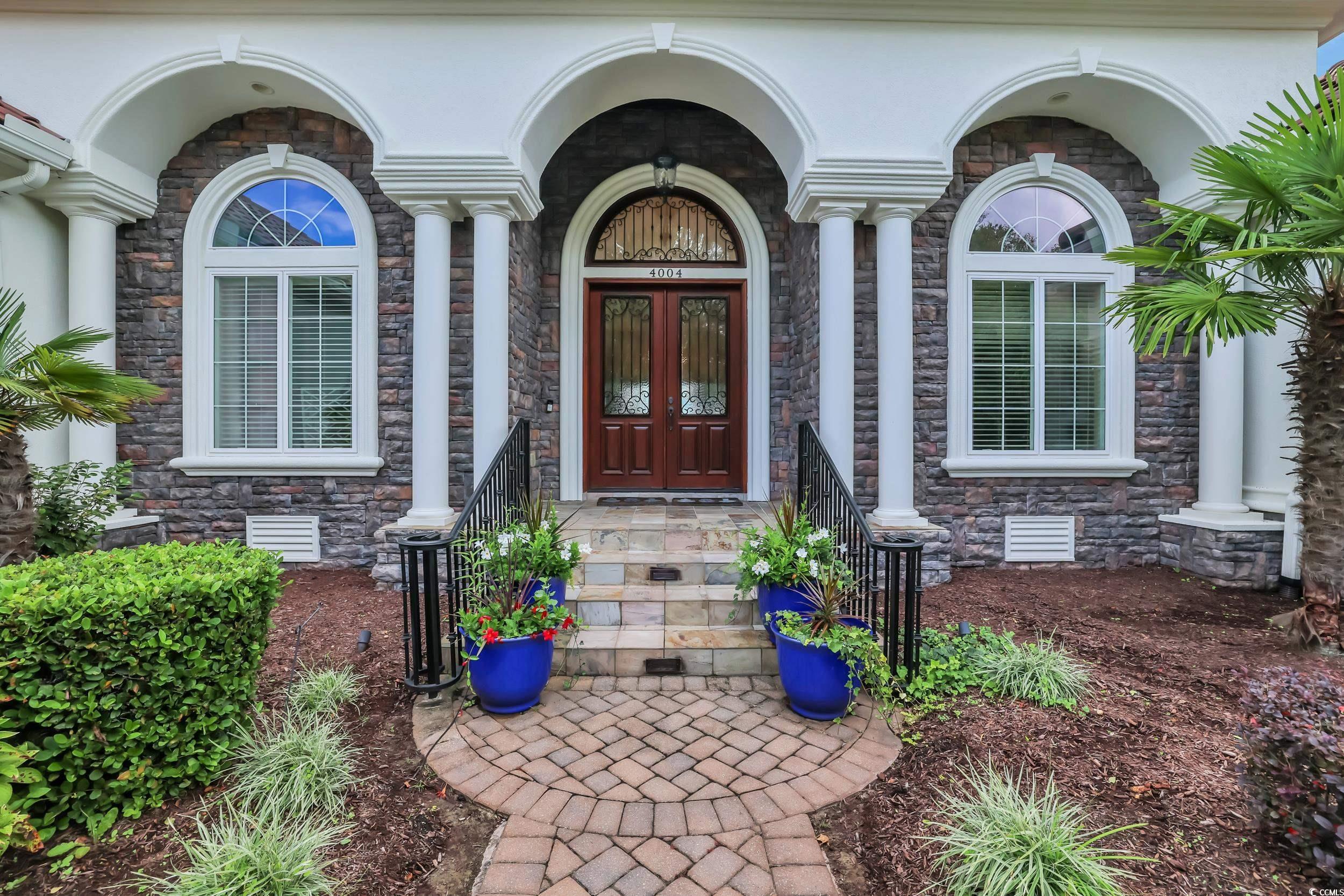 Image 4: Doorway to property featuring stone siding and stu