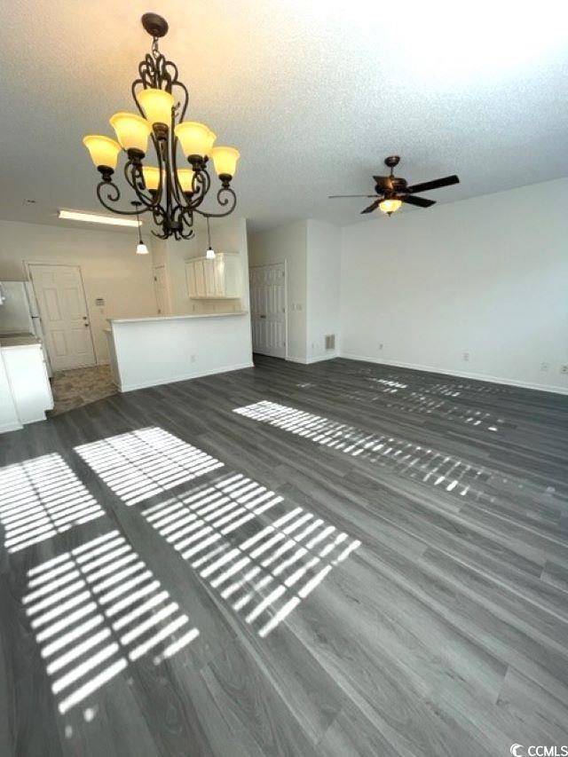 Image 2: Unfurnished living room with a textured ceiling, d