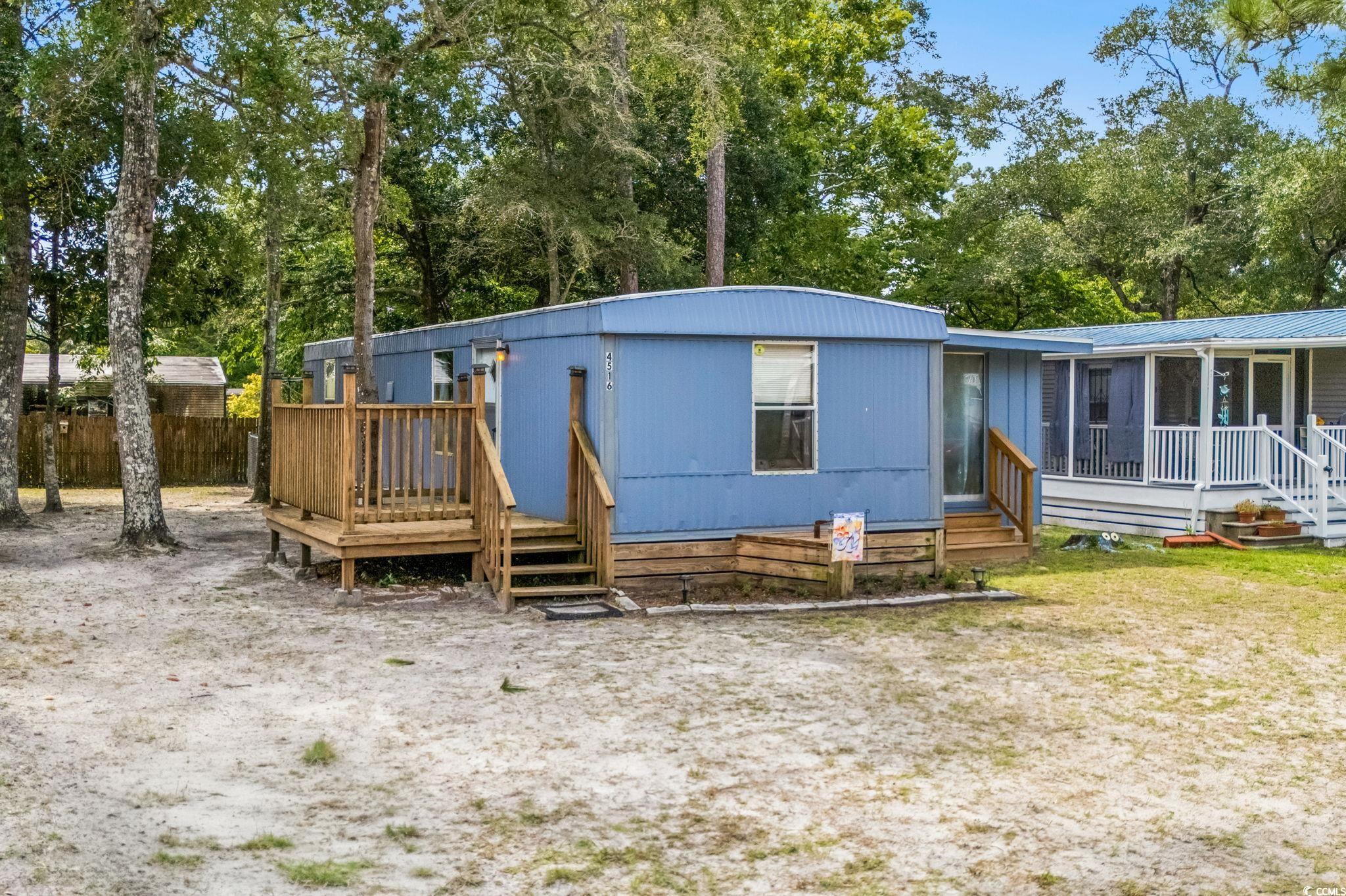 Image 1: View of front of property with view of wooded area Image 1: View of front of property with view of wooded area