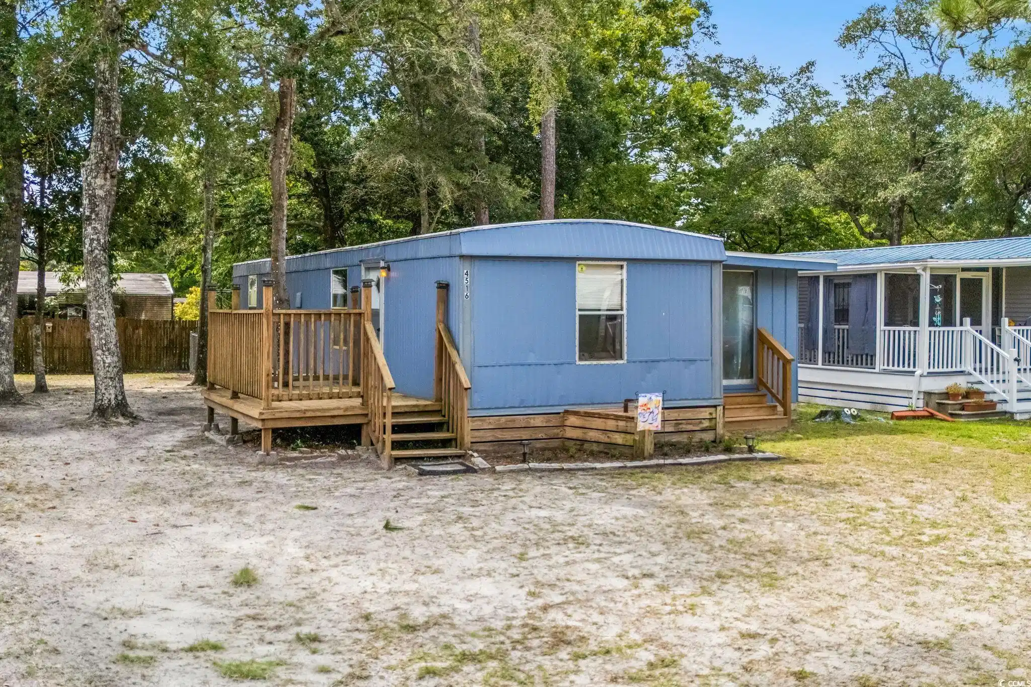 Image 1: View of front of property with view of wooded area