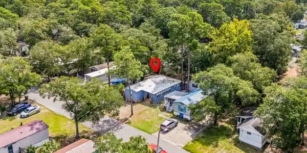 Image 3: View of urban area featuring a forest