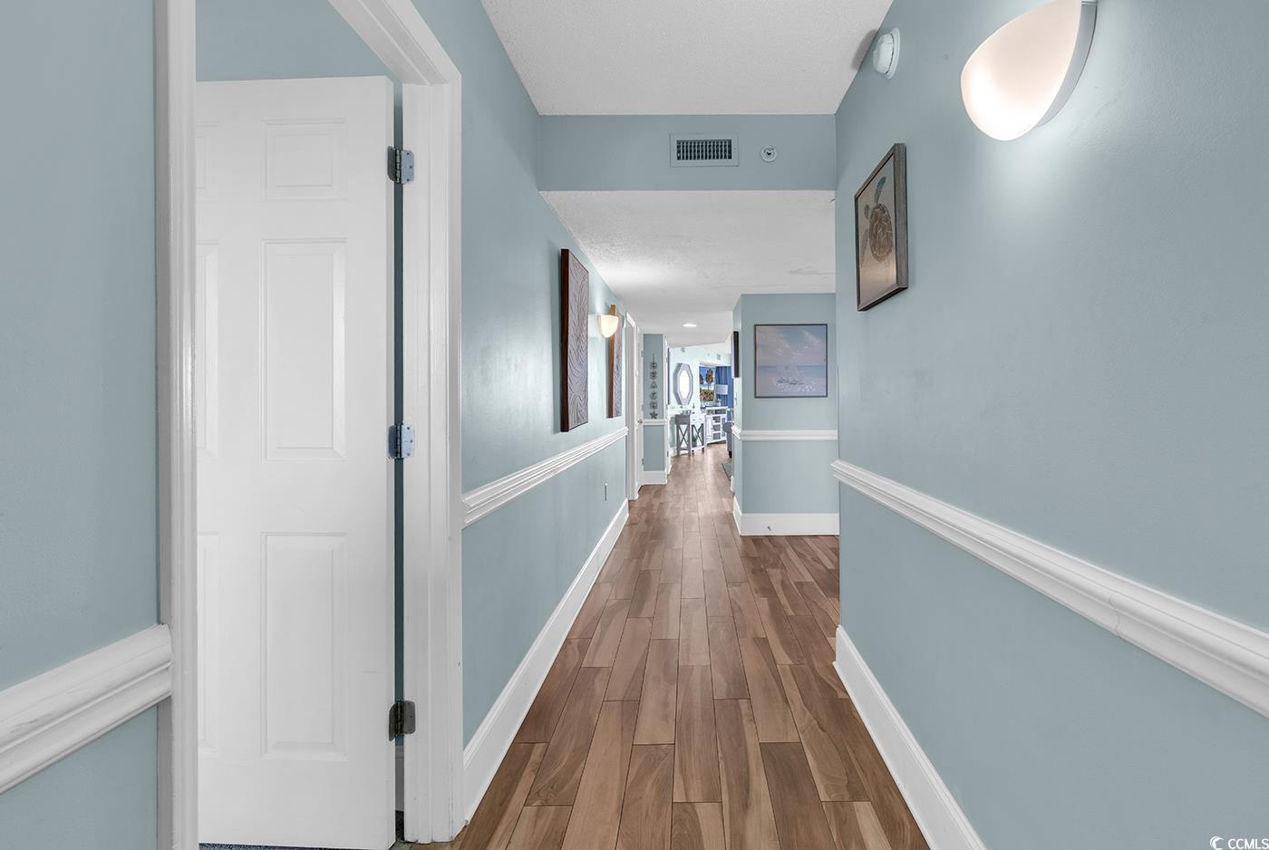 Image 2: Hallway featuring wood finished floors and baseboa Image 2: Hallway featuring wood finished floors and baseboa