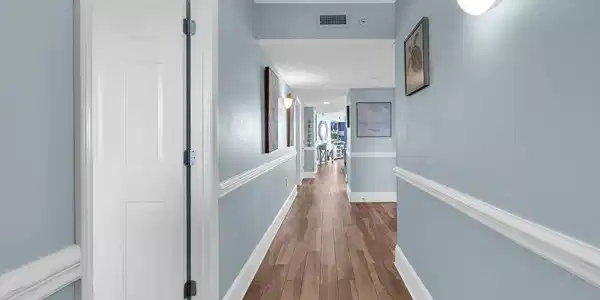 Image 2: Hallway featuring wood finished floors and baseboa Image 2: Hallway featuring wood finished floors and baseboa
