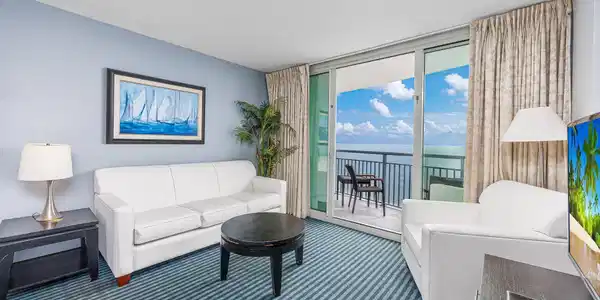 Image 4: Carpeted living area with floor to ceiling windows