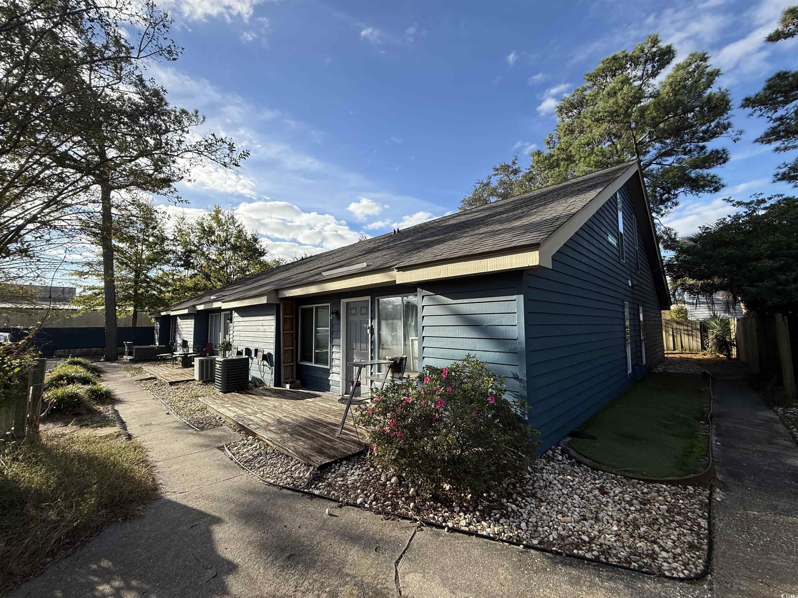 Image 1: View of side of home with a deck and a cooling uni Image 1: View of side of home with a deck and a cooling uni