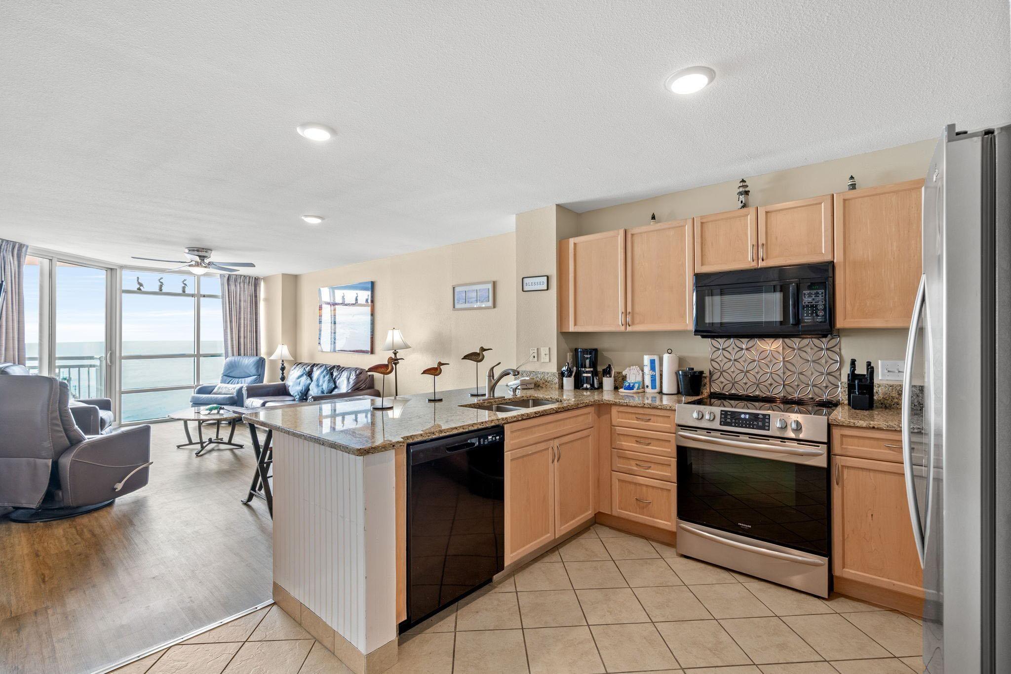 Image 2: Kitchen with light brown cabinets, open floor plan Image 2: Kitchen with light brown cabinets, open floor plan