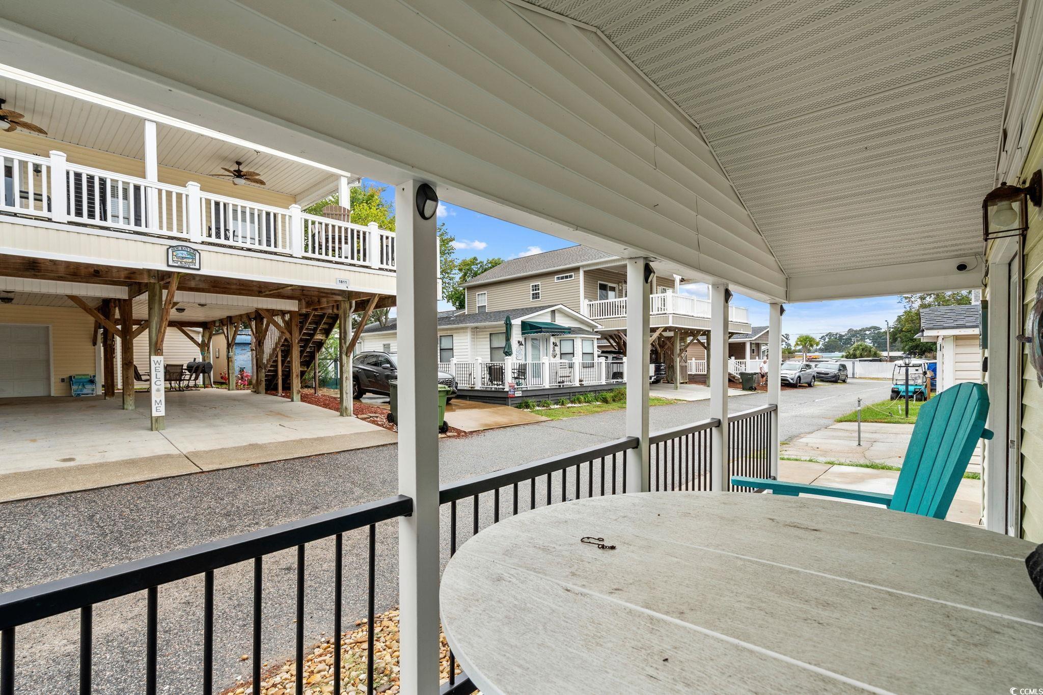 Image 4: Covered porch featuring a ceiling fan, stairway, a