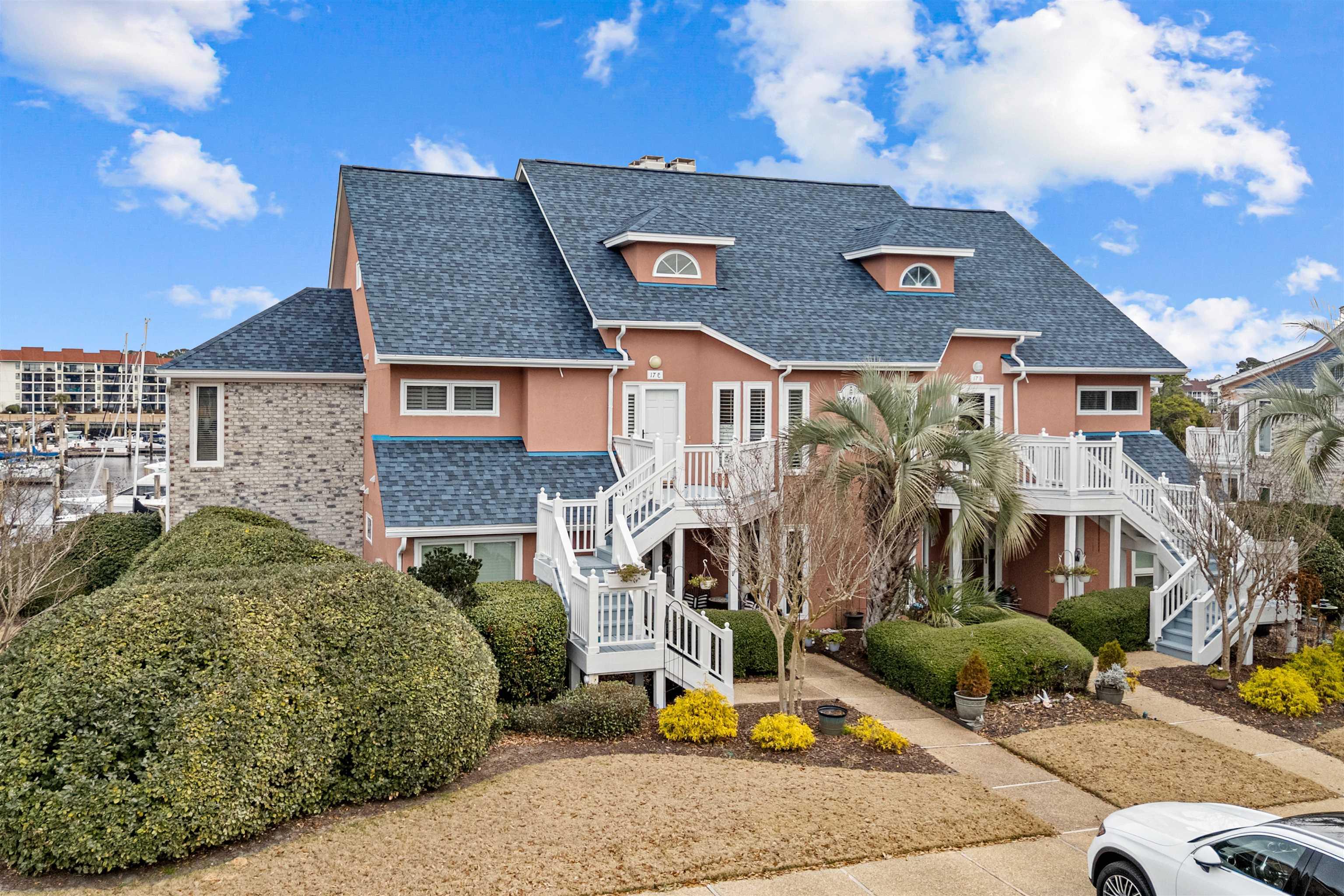 Image 1: View of front facade featuring a shingled roof, st