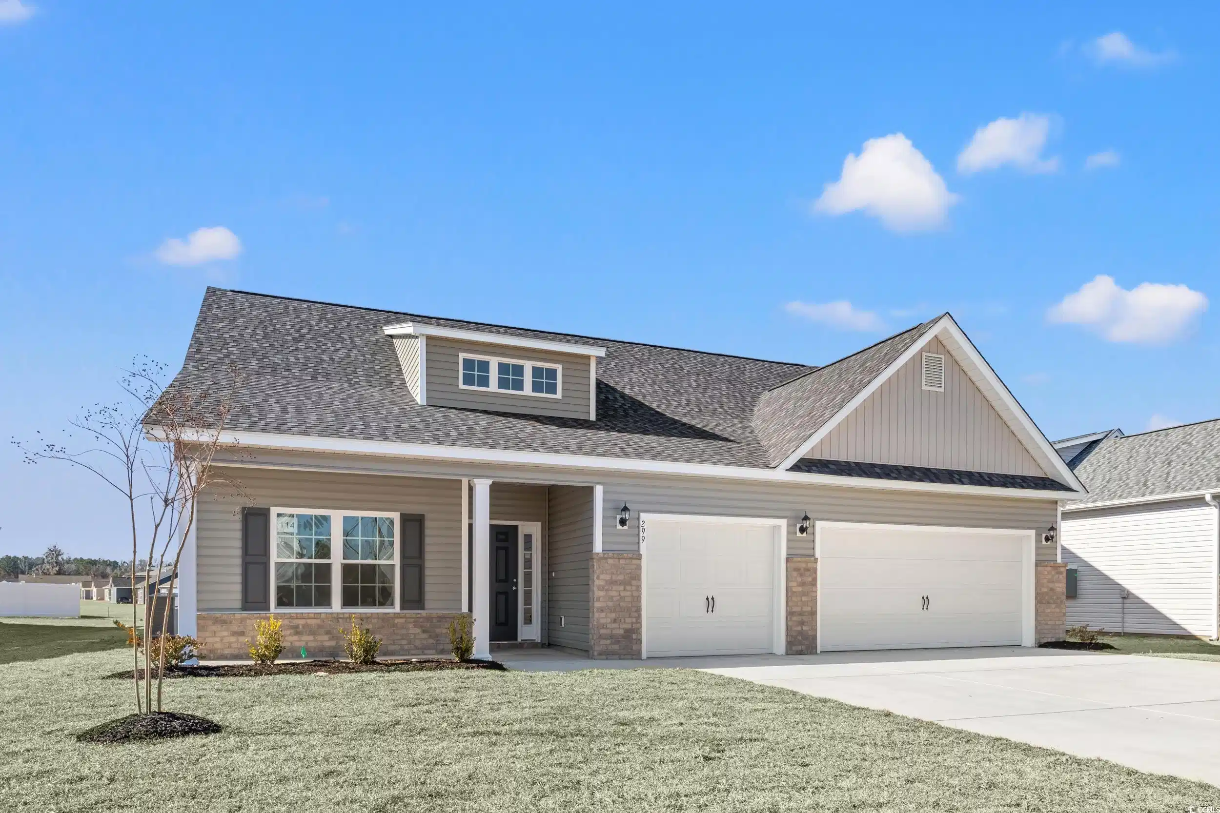 Image 1: View of front of home with a garage and a front la