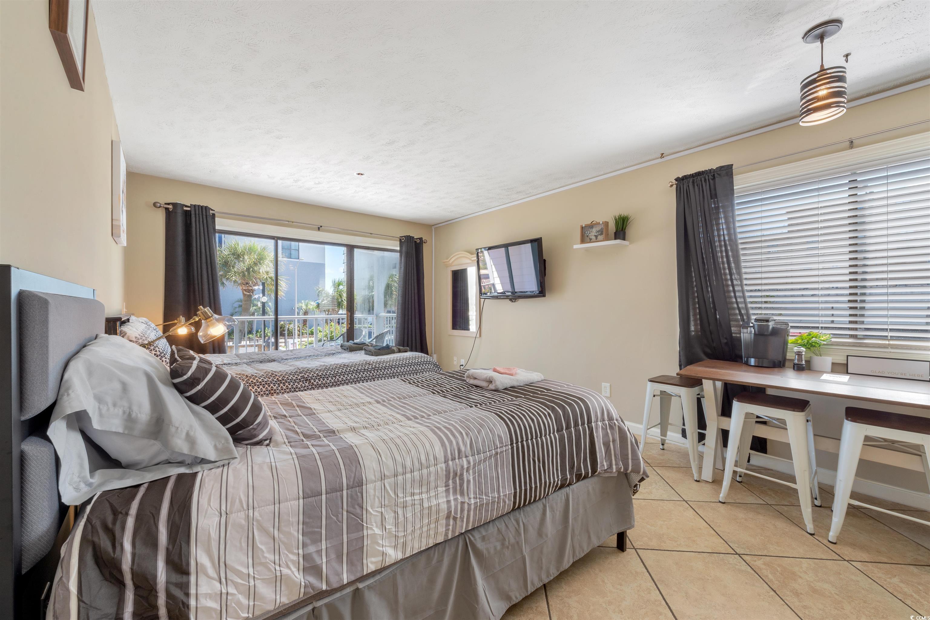 Image 4: Bedroom with light tile patterned flooring and a t Image 4: Bedroom with light tile patterned flooring and a t