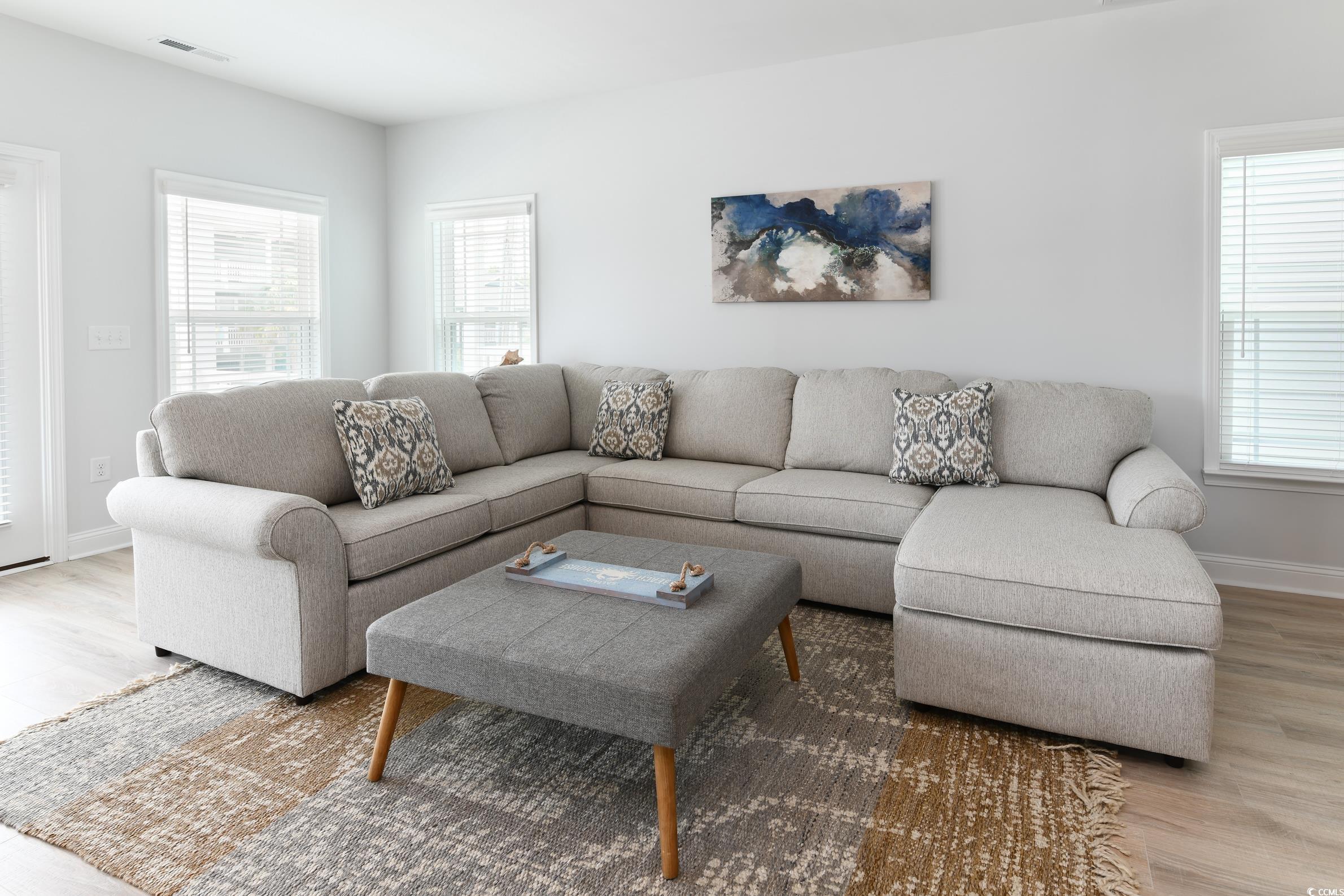 Image 3: Living area with wood finished floors