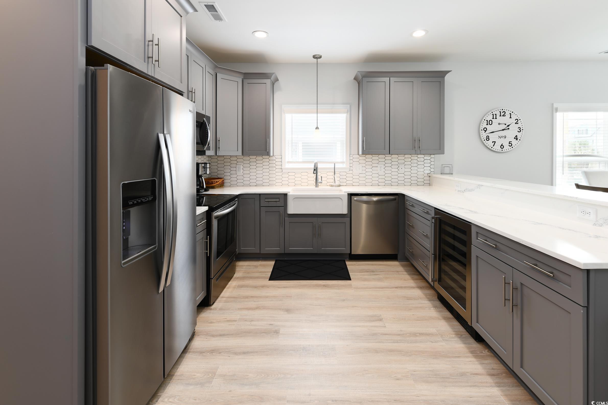 Image 4: Kitchen featuring stainless steel appliances, gray