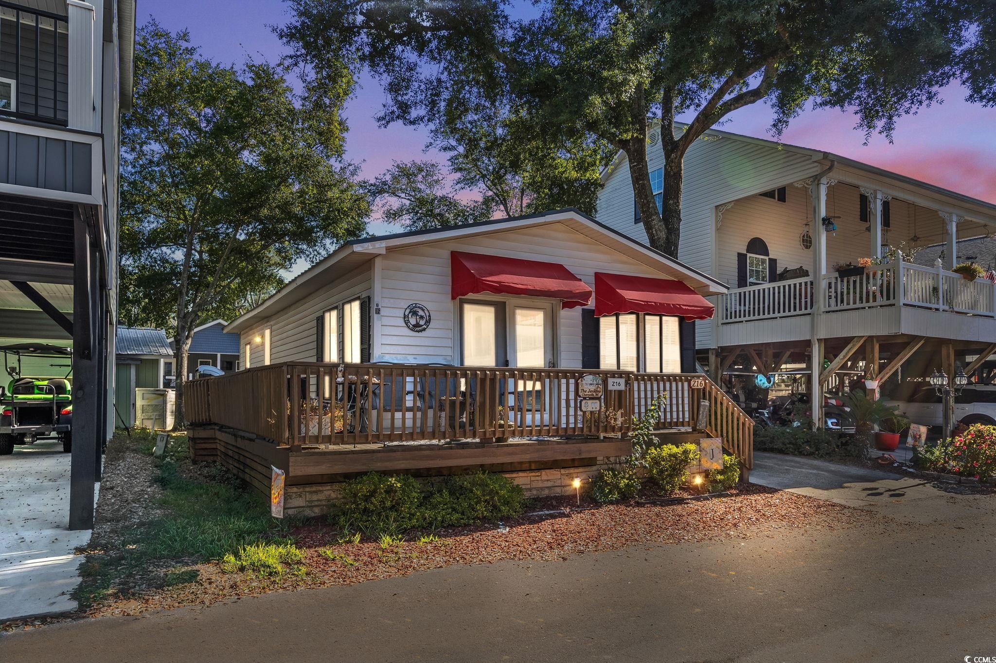 Image 1: View of front of house featuring a deck Image 1: View of front of house featuring a deck