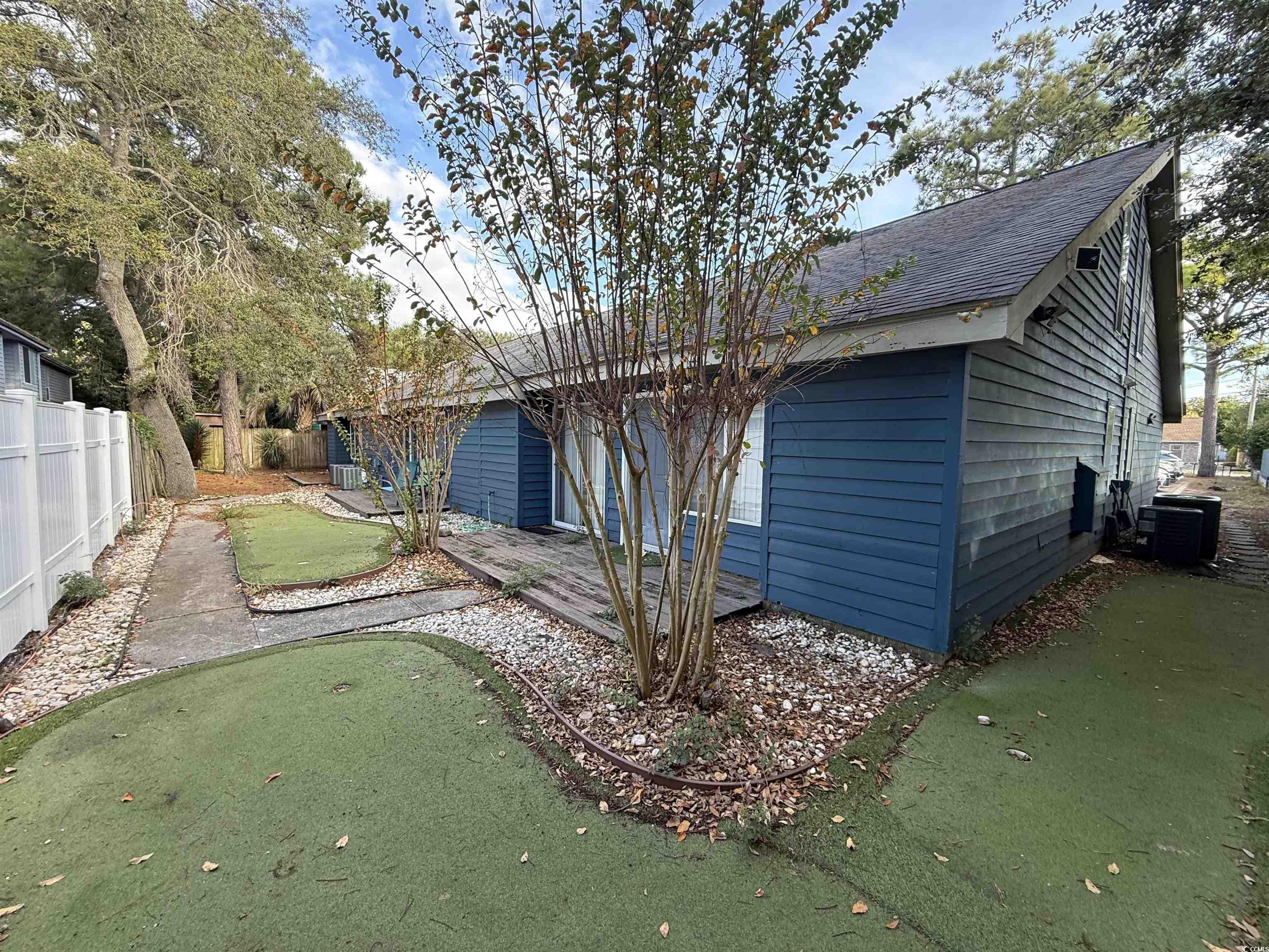 Image 3: Rear view of property with a putting green, a fenc Image 3: Rear view of property with a putting green, a fenc