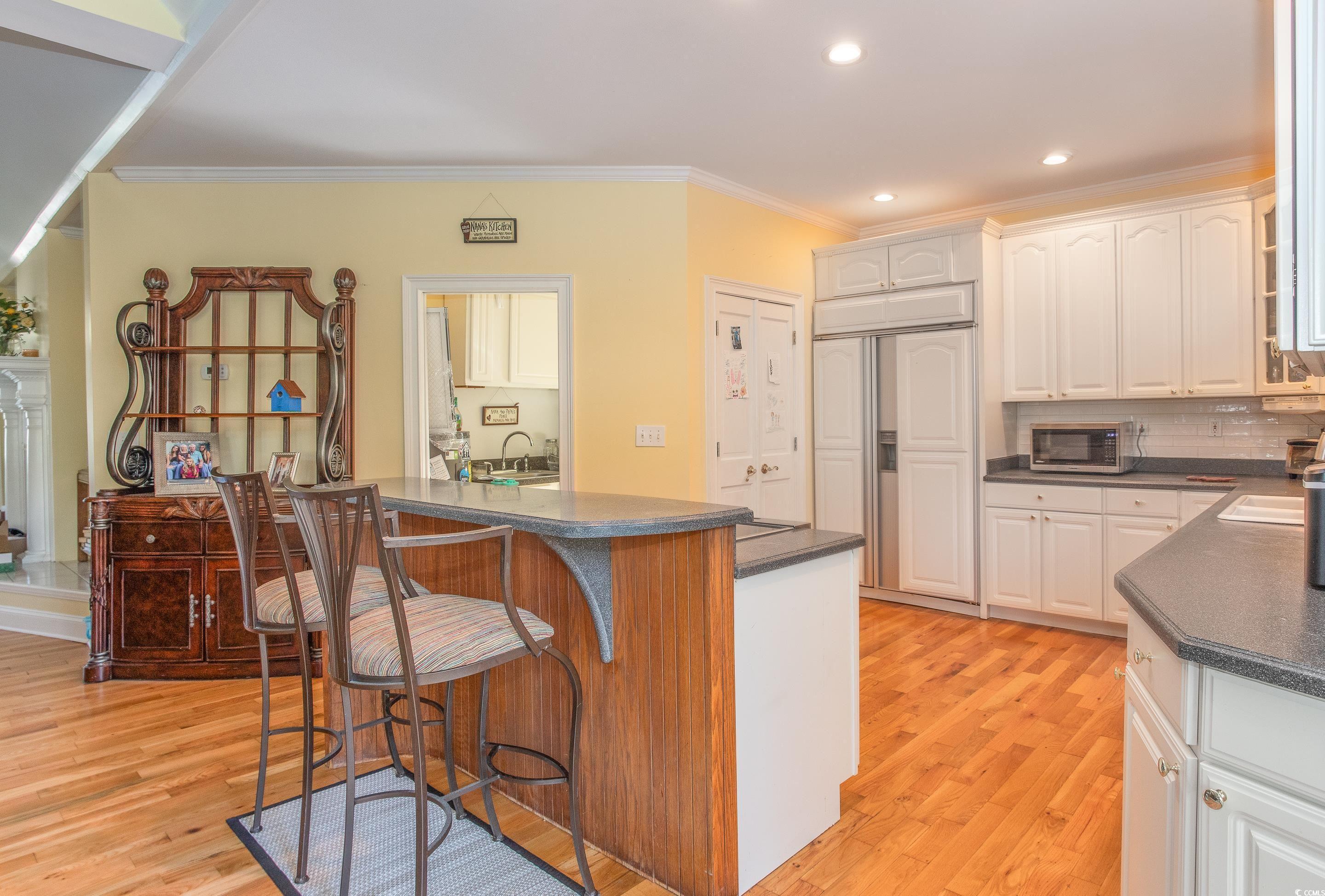 Image 3: Kitchen featuring dark countertops, light wood-sty Image 3: Kitchen featuring dark countertops, light wood-sty