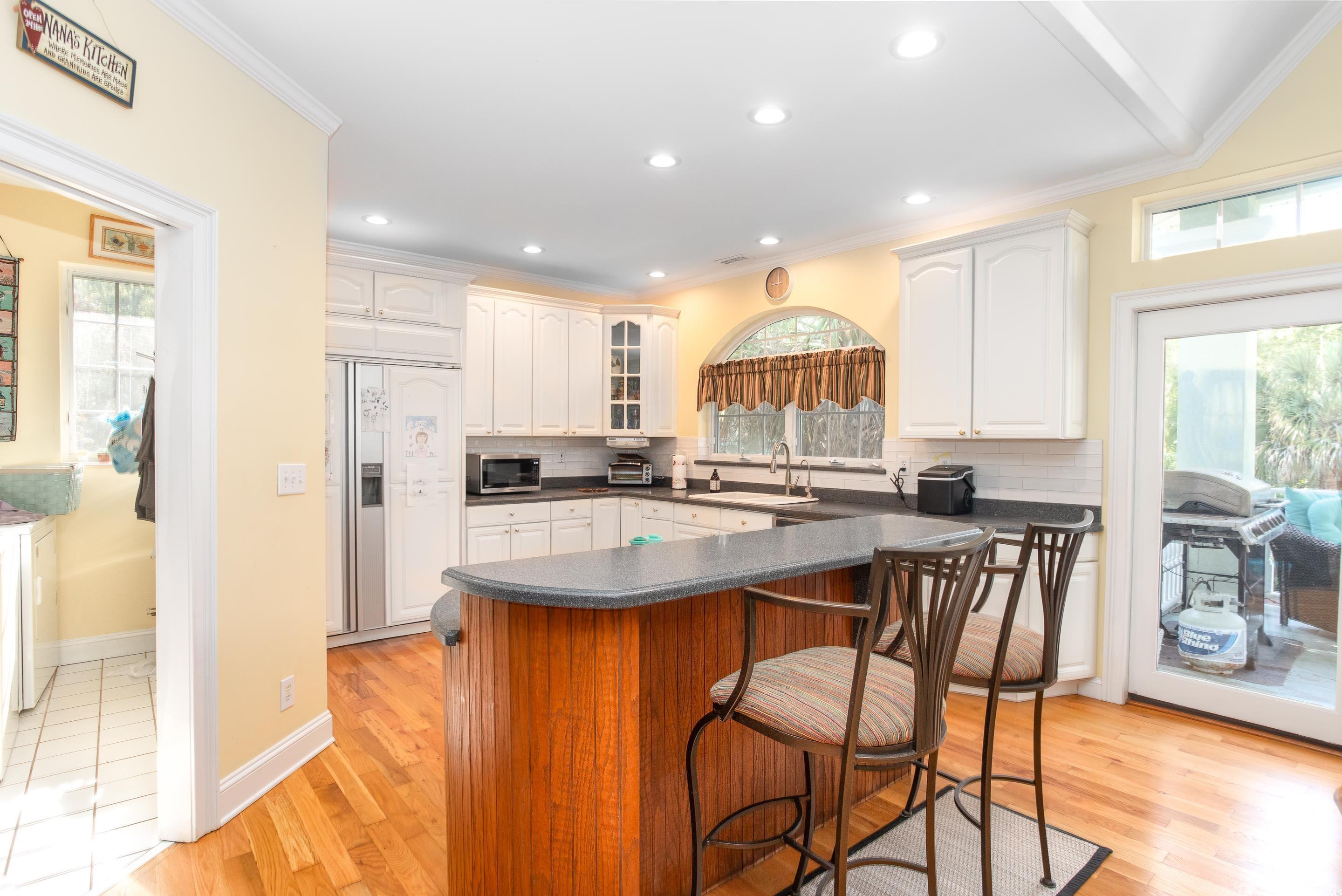 Image 4: Kitchen with dark countertops, tasteful backsplash Image 4: Kitchen with dark countertops, tasteful backsplash