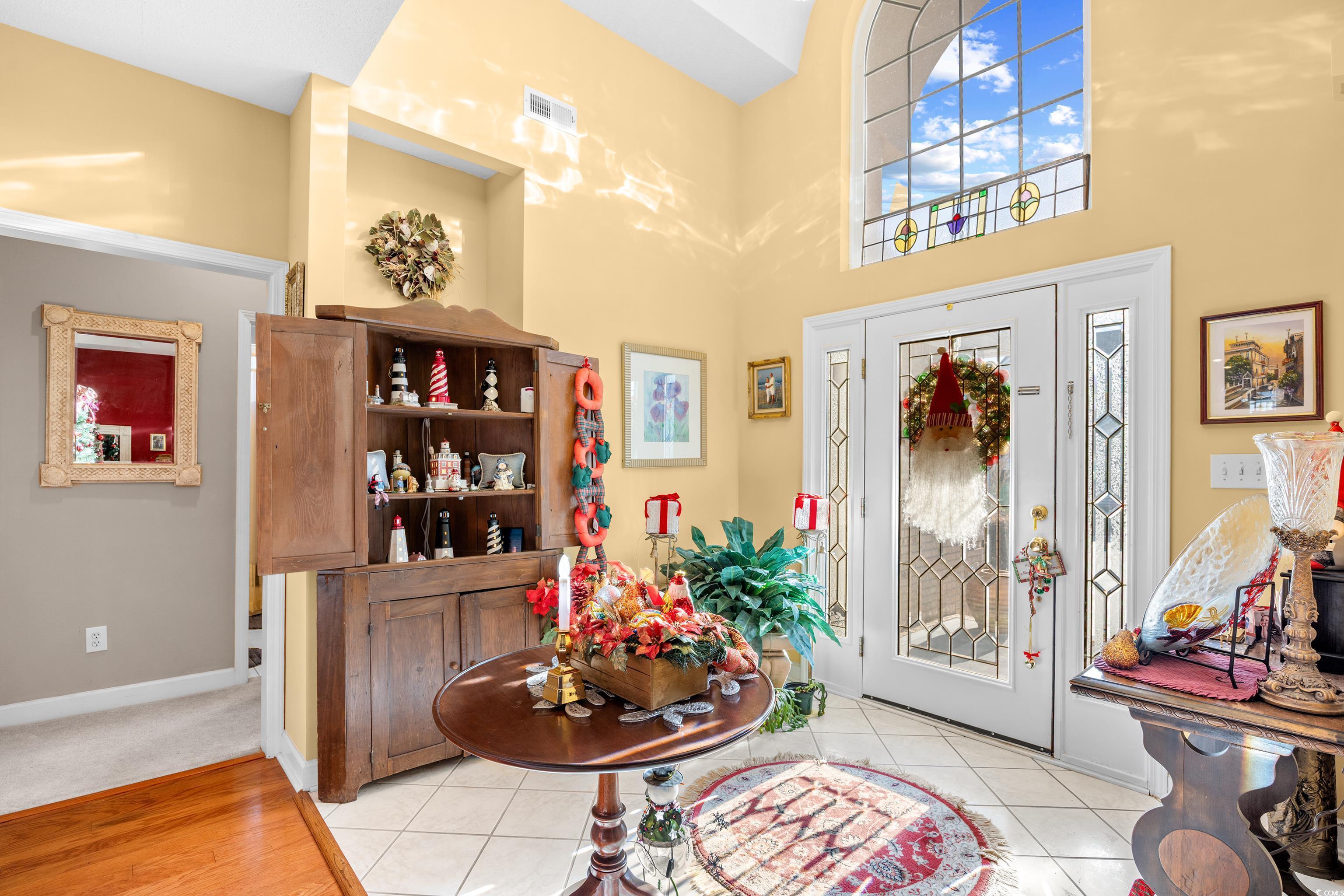 Image 4: Entrance foyer with a towering ceiling and light t