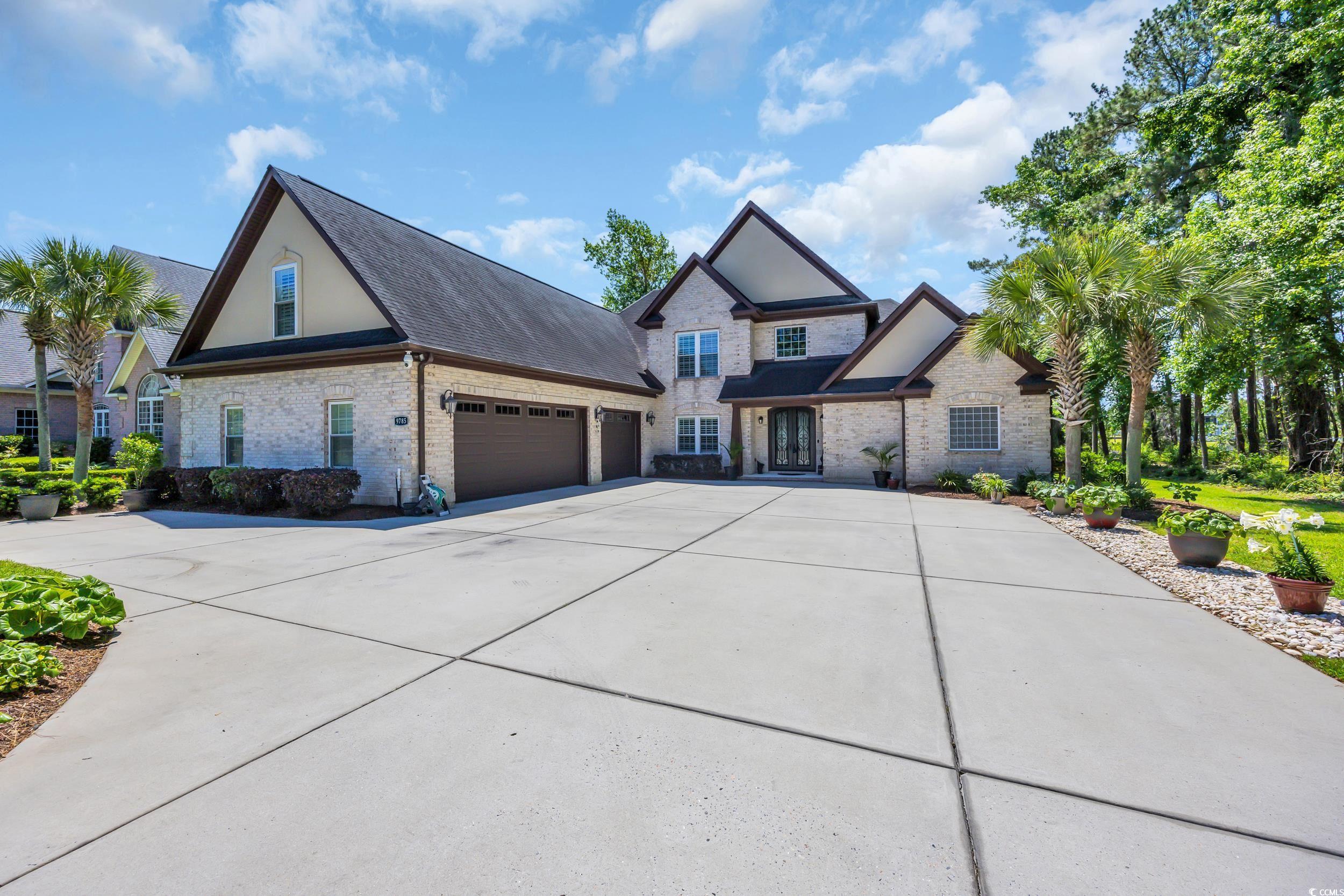 Image 1: View of front of property with brick siding, drive