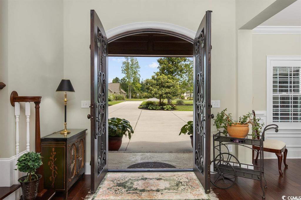 Image 4: Entryway featuring crown molding and wood finished