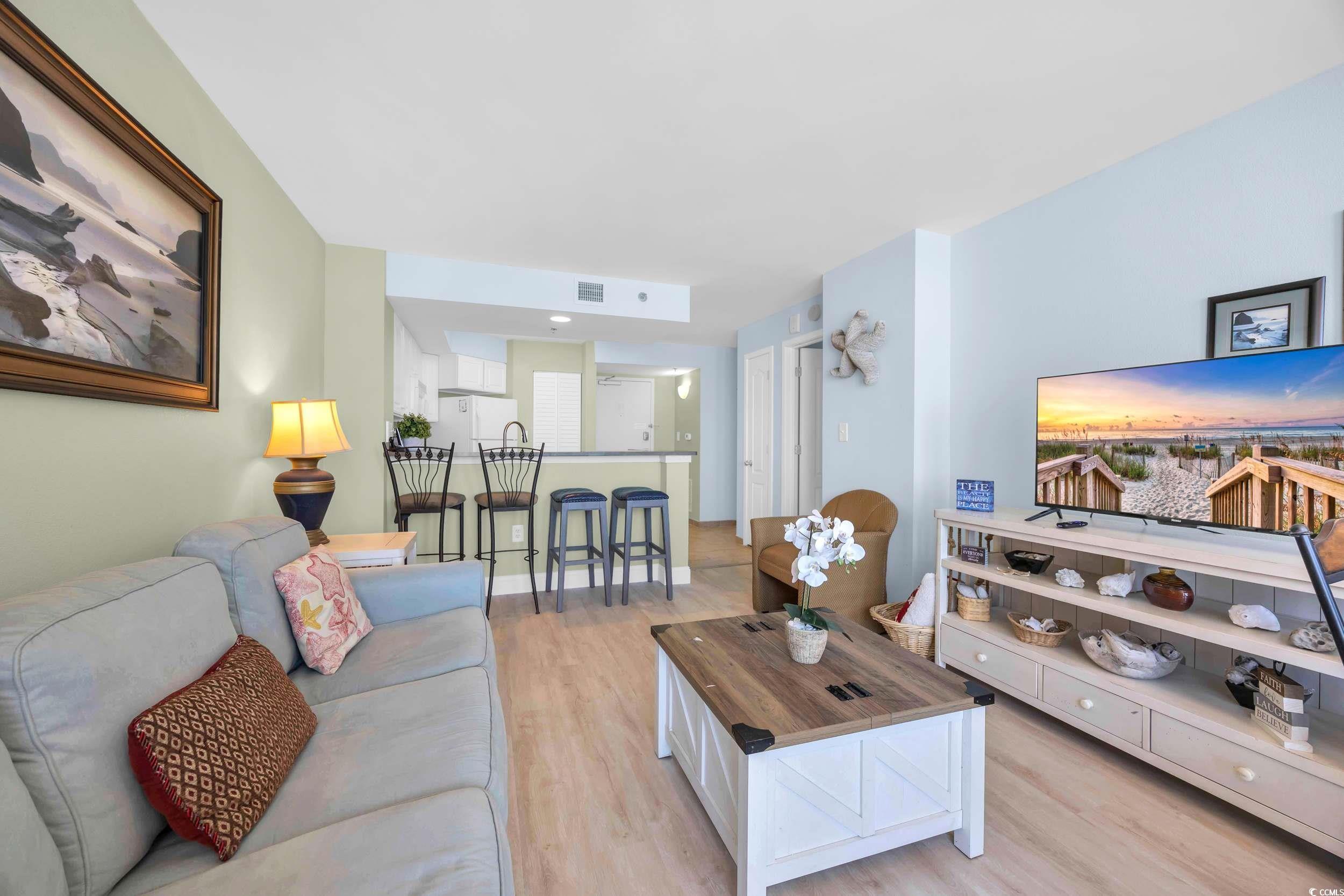 Image 2: Living room featuring light wood-style floors