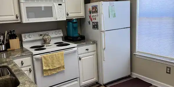 Image 4: Kitchen with white appliances, white cabinets, a t Image 4: Kitchen with white appliances, white cabinets, a t